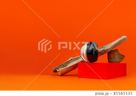 Cosmetic face BB cream tonal foundation glass jar mockup natural wood podium orange background. Balancing makeup product 85565535