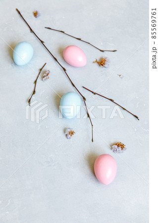 Happy Easter concept. Preparation for holiday. Colorful decorated easter eggs spring branches on concrete stone grey background. Simple minimalism flat lay top view copy space 85569761