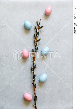 Happy Easter concept. Preparation for holiday. Colorful decorated easter eggs willow on concrete stone grey background. Simple minimalism flat lay top view copy space 85569762