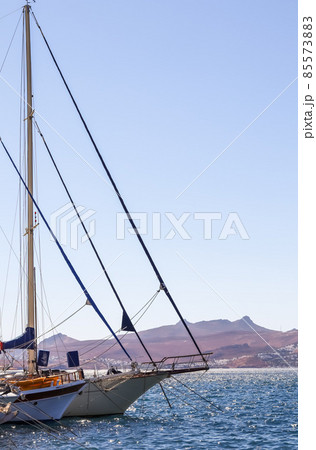 Sailboats in the blue sea against the backdrop of islands and mountains. Sports and summer vacations concept Sailboats in the blue sea against the backdrop of islands and mountains. Sports and summer vacations concept 85573883