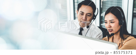 Business team wearing headset working actively in office 85575371