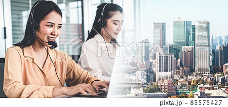 Business team wearing headset working actively in office 85575427