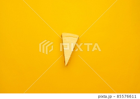 Piece of tasty cream cheesecake on yellow background Piece of tasty cream cheesecake on yellow background 85576611