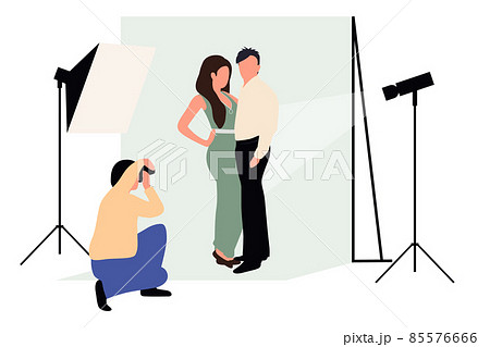 Professional photographers taking pictures. Men and woman models posing in professional photography studio with cameras and light tripods. 85576666