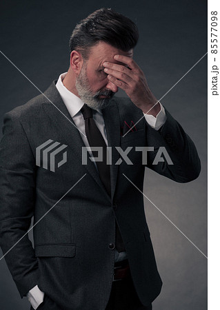 Frustrated middle aged elegant man Close up face of stressed businessman wearing stylish suit with eyes closed. Overworked middle eastern business man with terrible migrain 85577098