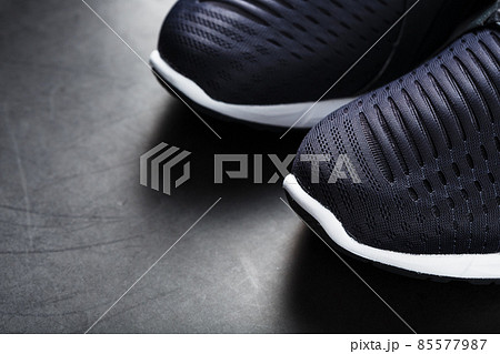 Black and white ultra-modern sports sneakers on a black background. 85577987