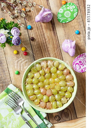 Holiday food, easter salad. Salad with chicken, cheese, walnuts and grapes on a festive table. Top view flat lay. Holiday food, easter salad. Salad with chicken, cheese, walnuts and grapes on a festive table. Top view flat lay. 85578932