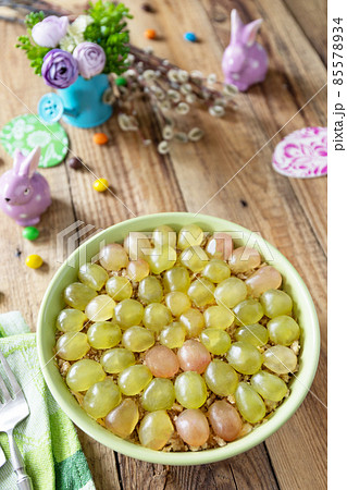 Holiday food, easter salad. Salad with chicken, cheese, walnuts and grapes on a festive table. Holiday food, easter salad. Salad with chicken, cheese, walnuts and grapes on a festive table. 85578934