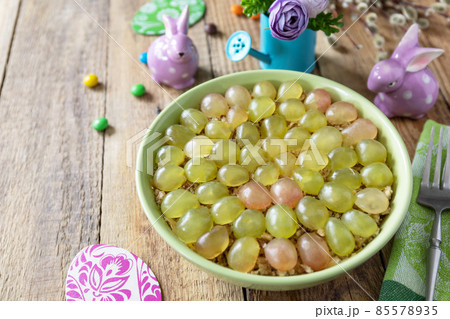 Holiday food, easter salad. Salad with chicken, cheese, walnuts and grapes on a festive table. Copy space. Holiday food, easter salad. Salad with chicken, cheese, walnuts and grapes on a festive table. Copy space. 85578935