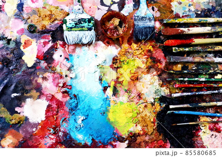 Close up paint brushes on a color full painter in black ground. Close up paint brushes on a color full painter in black ground. 85580685