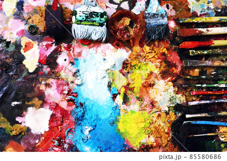 Close up paint brushes on a color full painter in black ground. 85580686