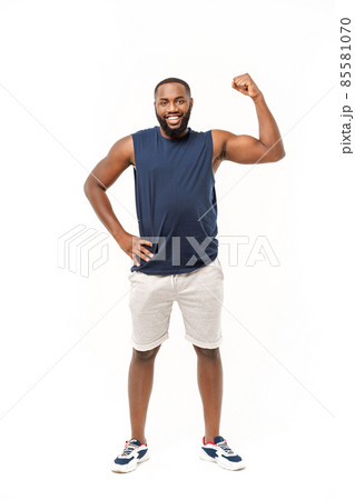 African American teenager shows muscles on arm. Isolated on white background. Studio portrait. Transitional age concept African American teenager shows muscles on arm. Isolated on white background. Studio portrait. Transitional age concept 85581070