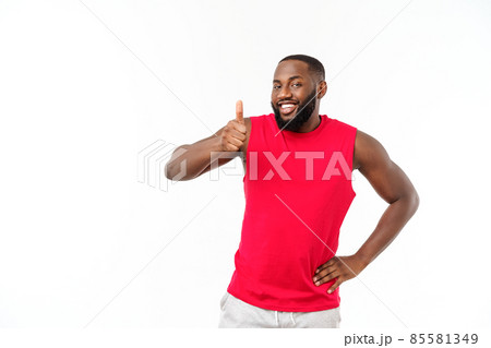 Young african american man over isolated background wearing sport wear smiling with happy face looking with thumb up. 85581349