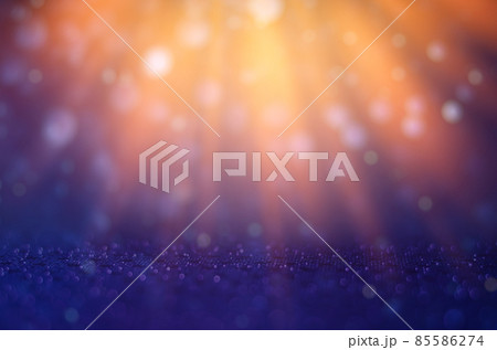 The background is blue, orange and light shines down to celebrate. 85586274