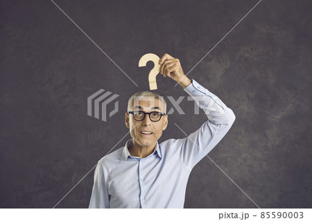 Studio portrait of curious intelligent old senior man looking at question mark with confused face expression, trying to find answer, thinking of interesting idea, developing cognitive abilities 85590003