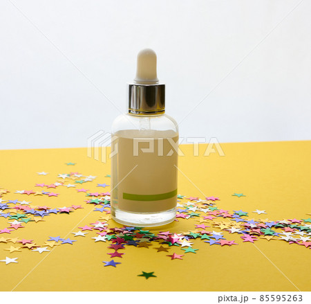 white glass bottle with a pipette and a empty white label. Container for cosmetics, serum and oil. Mockup skincare product 85595263