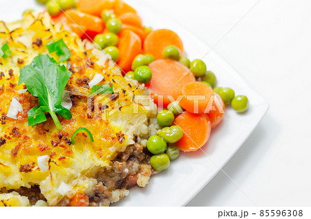 Shepherd's pie, tender minced lamb with garden veg in a hearty gravy beneath butter mash with carrots and green peas Shepherd's pie, tender minced lamb with garden veg in a hearty gravy beneath butter mash with carrots and green peas 85596308
