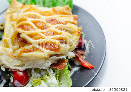 Chicken en croute, chicken breast inner fillets with mature cheddar cheese and beechwood smoked streaky bacon in a puff pastry lattice 85596321