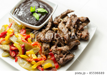 Beef strips with mixed peppers and mangetout served with black bean sauce Beef strips with mixed peppers and mangetout served with black bean sauce 85596689
