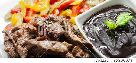 Beef strips with mixed peppers and mangetout served with black bean sauce Beef strips with mixed peppers and mangetout served with black bean sauce 85596973