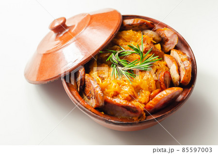 Traditional Polish dish called bigos made of sauerkraut, sausage and mushrooms, food served warm in a ceramic bowl 85597003