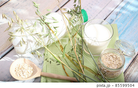 An alternative to animal milk is oat milk on a light table . Vegan product An alternative to animal milk is oat milk on a light table . Vegan product 85599504