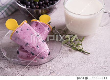 Melting homemade excimo ice cream with berries on a transparent plate.Homemade summer desserts 85599511