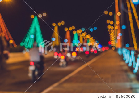 Busy traffic on a bridge at night. Glowing bridge supports. Blurred focus 85600030