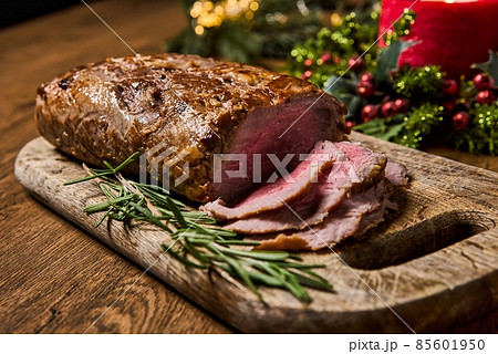 Sliced Baked roast meat, isolated on wooden background. Sliced Baked roast meat, isolated on wooden background. 85601950