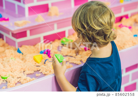 Boy playing with kinetic sand in preschool. The development of fine motor concept. Creativity Game concept 85602558