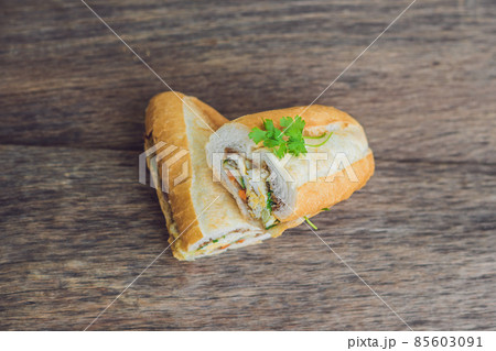 A delicious Vietnamese Bahn Mi sandwich on a wooden background 85603091