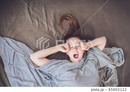 Beautiful young woman lying down in bed and sleeping, top view. Do not get enough sleep concept Beautiful young woman lying down in bed and sleeping, top view. Do not get enough sleep concept 85603122