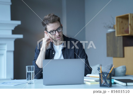 Focused confident german businessman corresponding with customer supplier by email on laptop 85603510