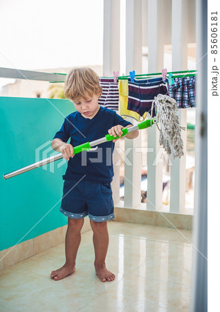 kid boy cleaning room, washing floor with mop. Little home helper kid boy cleaning room, washing floor with mop. Little home helper 85606181