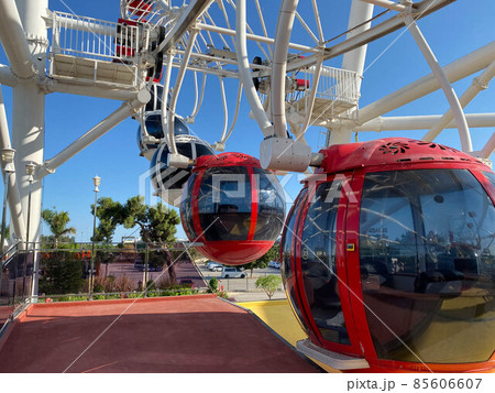 Big white ferris wheel against the blue sky. Part of the attraction on a blue background with copy space. Cabins, viewing platforms 85606607
