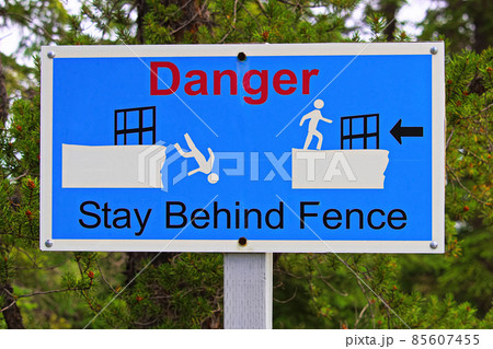 Closeup of a danger stay behind fence sign Closeup of a danger stay behind fence sign 85607455