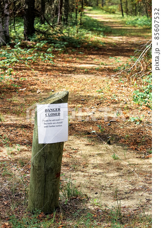 A trails closed sign with a path in the background 85607532