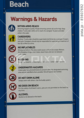 A beach warning and hazards sign with regulations A beach warning and hazards sign with regulations 85607692