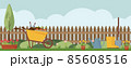 Spring landscape in the garden with green grass, flower, garden wheelbarrow, shovel. 85608516