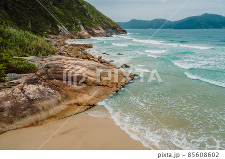 Tropical coastline with beach, rocks and clear ocean with waves in Brasil. 85608602