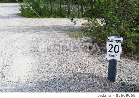 A maximum 20 km per hour sign along a gravel road A maximum 20 km per hour sign along a gravel road 85609069