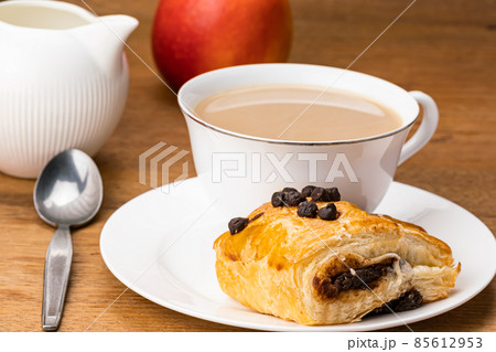 Danish Pasty filled with chocolate cream topping with chocolate chips with milk coffee. Danish Pasty filled with chocolate cream topping with chocolate chips with milk coffee. 85612953