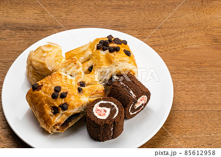 High angle view different kings of dessert in white ceramic dish.  85612958