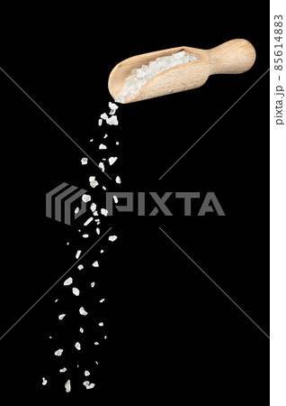 white sea salt falling from wooden spoon isolated 85614883