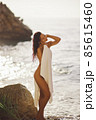 Adorable Beach Woman in the Towel Drying after Swimming on the Deserted Beach During Summer Vacation Outdoors 85615460