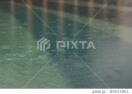 Rain drops falling in the swimming pool. 85615861