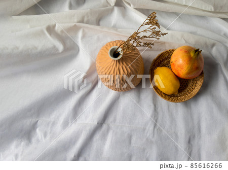 Dried flowers in Handmade Ceramic Vases and Fresh fruits on Wicker basket. 85616266