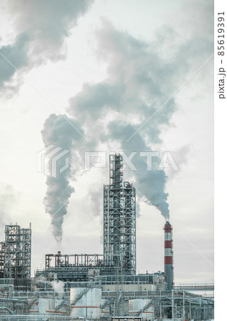 Petrochemical industrial factory of heavy industry, power refinery production with smoke pollution.Thick smoke is coming from the factory's chimney. smoke smog emissions bad ecology aerial photography Petrochemical industrial factory of heavy industry, power refinery production with smoke pollution.Thick smoke is coming from the factory's chimney. smoke smog emissions bad ecology aerial photography 85619391