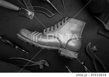 Handcrafted brown leather shoe with cobbler tools 85619838