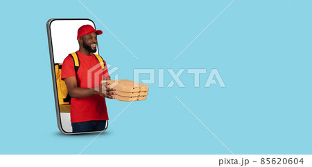 Online Order. Sblack delivery guy with pizza boxes peeking out of smartphone Online Order. Sblack delivery guy with pizza boxes peeking out of smartphone 85620604